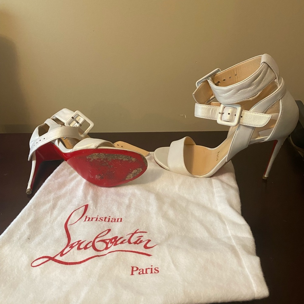 White Christian Louboutin heels with duster bags